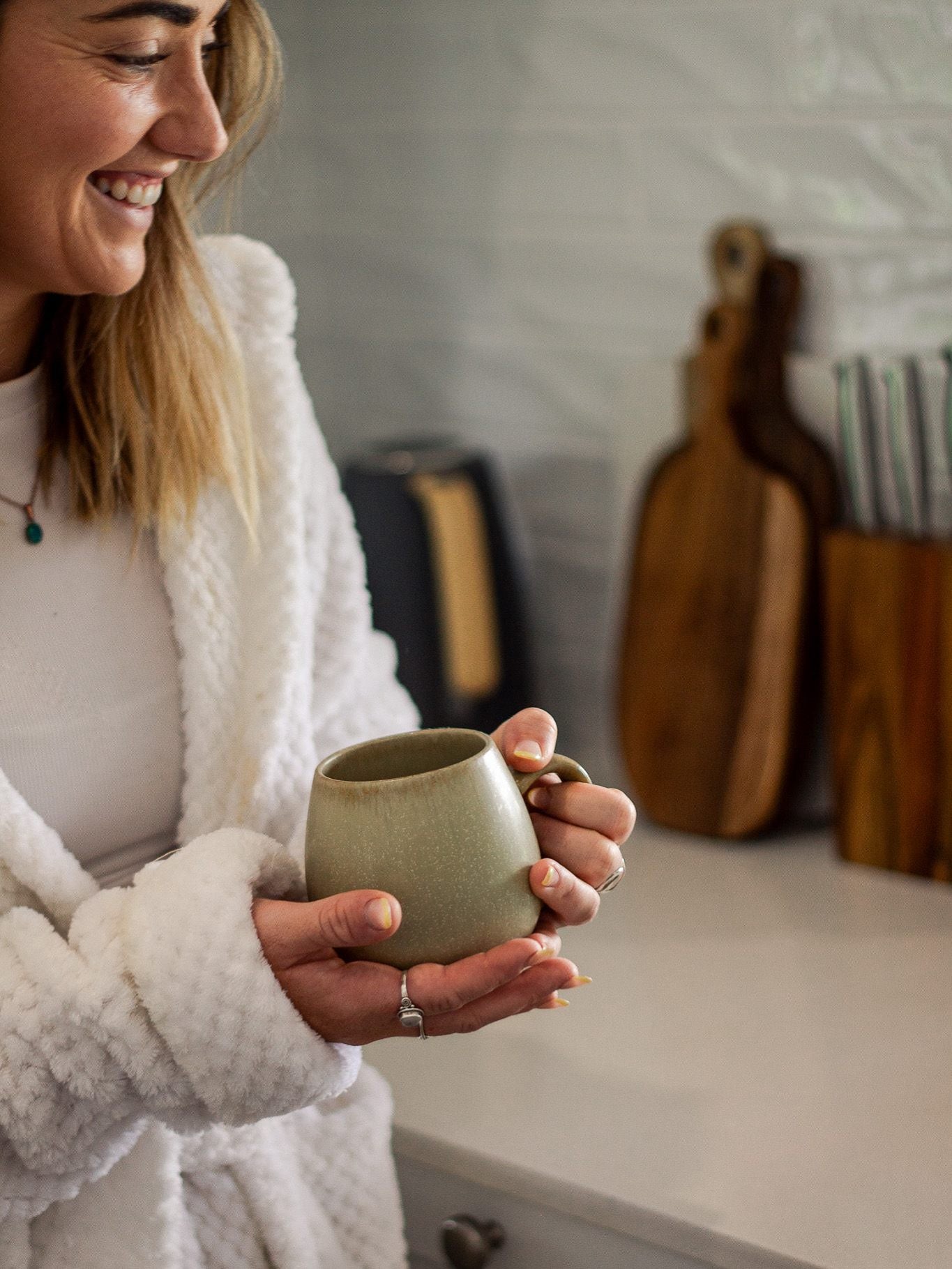 Woman in a robe enjoying her morning coffee ritual