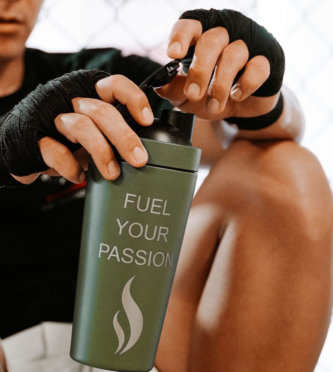 Athlete with hand wraps opening a Brewdy shaker