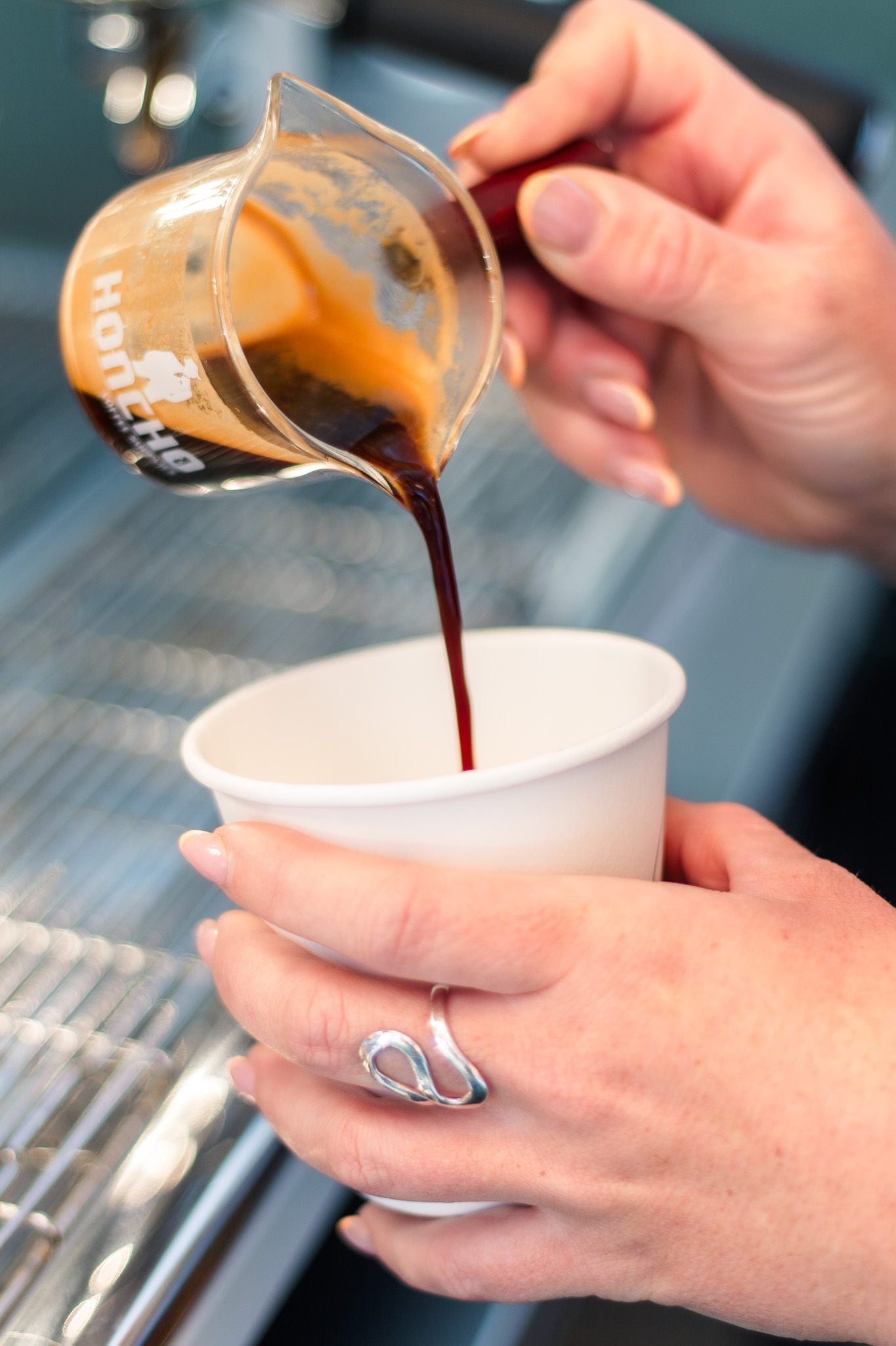 Rich espresso crema being poured at the machine